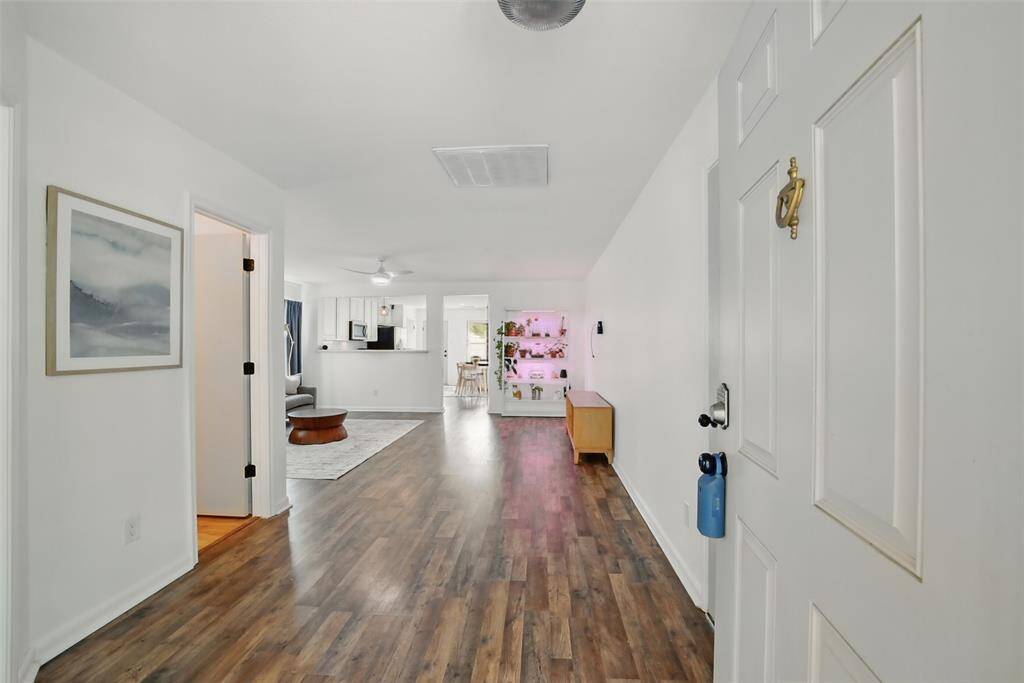 THE FRONT DOORS OPENS UP TO THE ENTRANCE HALL WITH RICH HARDWOOD FLOORS THAT CONTINUE THROUGHOUT THE MAIN LIVING AREAS.