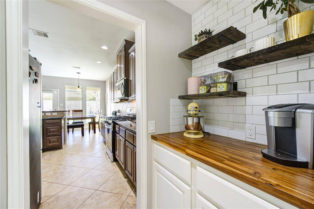 Butler’s pantry is currently used as coffee bar with its elegant butcher's block countertop.