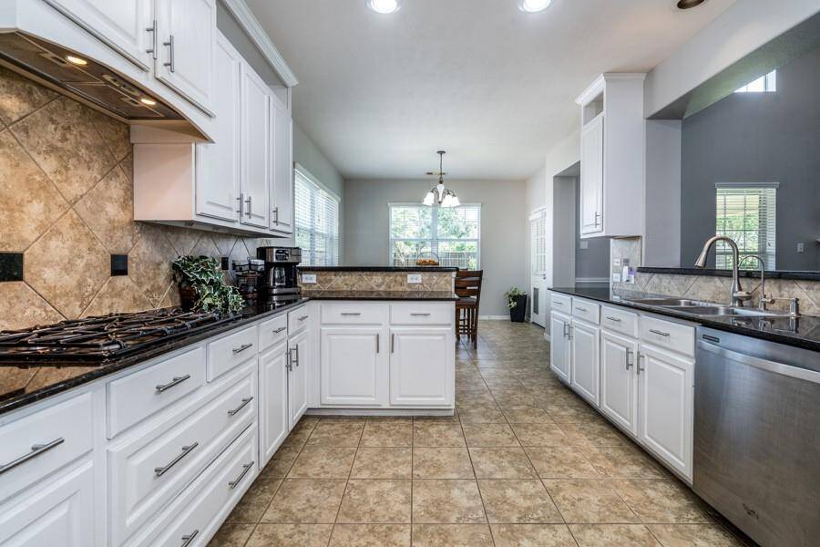The kitchen was recently refreshed with white cabinetry.