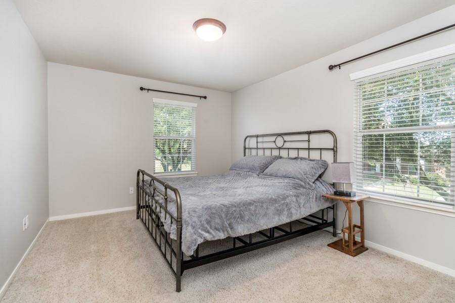 This secondary bedroom has a beautiful view of the lake.