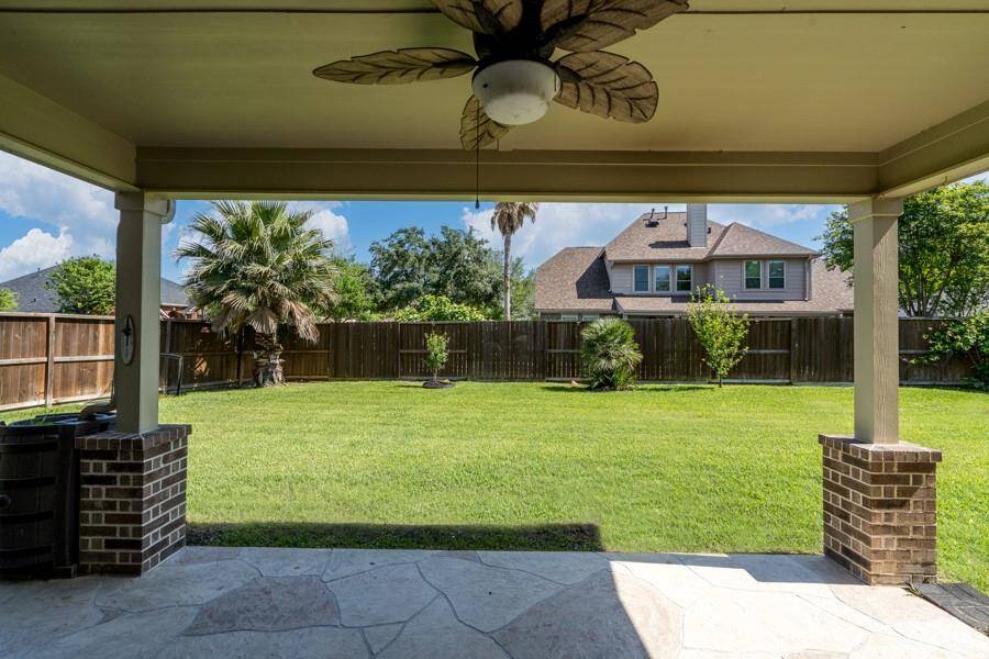 The stamped concrete floor is a nice touch to this large covered patio.