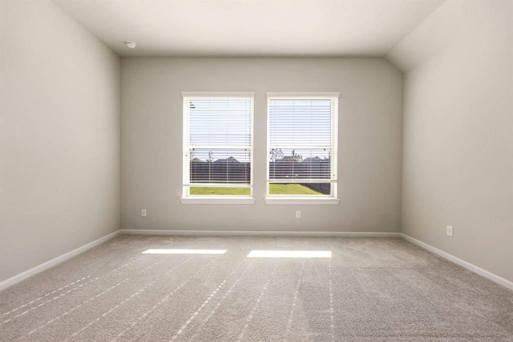 Master bedroom features a peaceful view and plush carpeting for added comfort