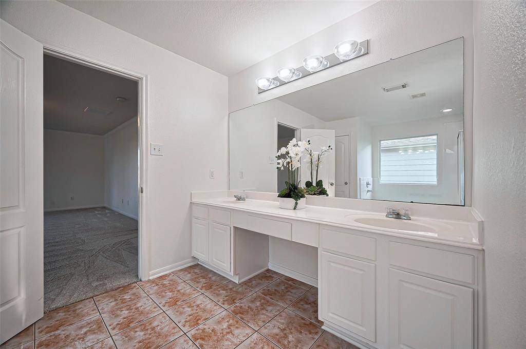 Double sinks, vanity, jetty soaking tub, separate shower, large walk-in closet
