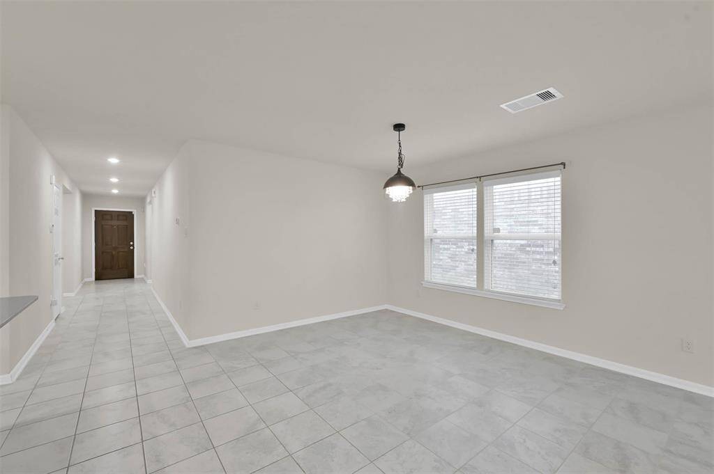 Standing in middle living/dining looking back down entry hallway and front door