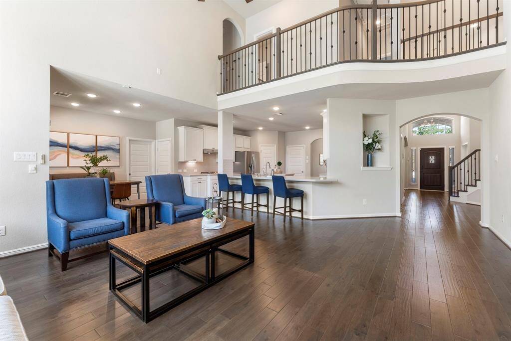 The family room offers two story ceilings with stone fireplace, and sits center stage with kitchen and breakfast room surrounding.
