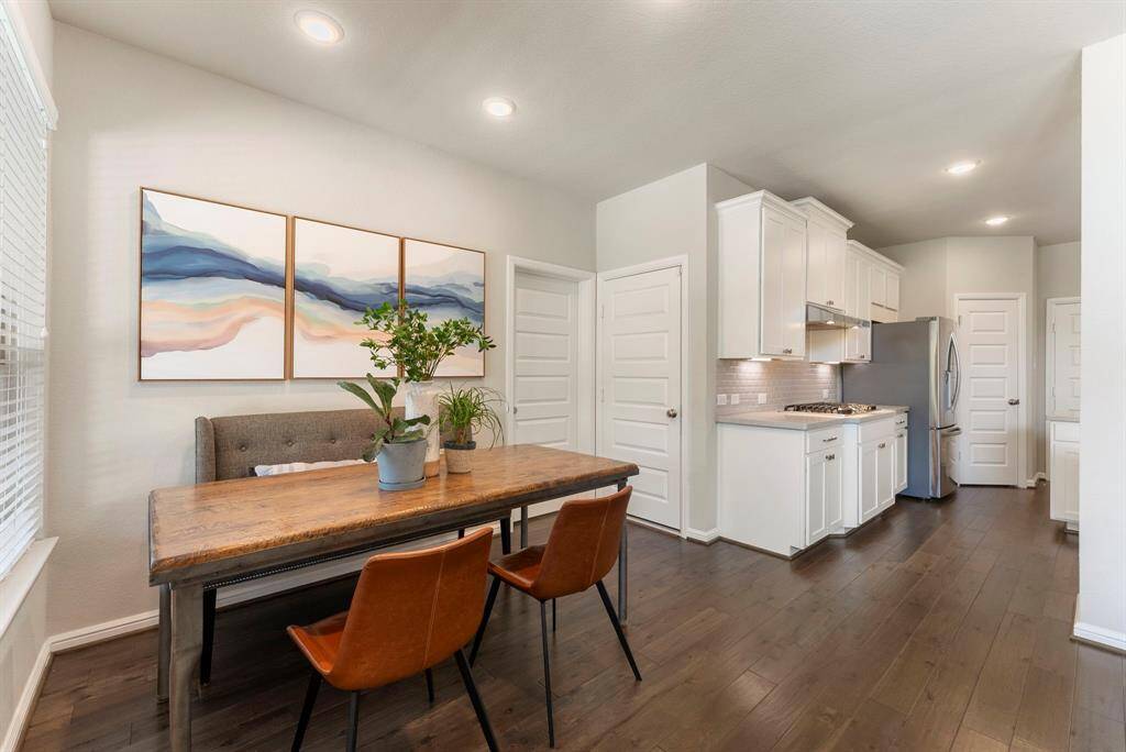 Breakfast room adjacent kitchen with door to laundry room in the center.