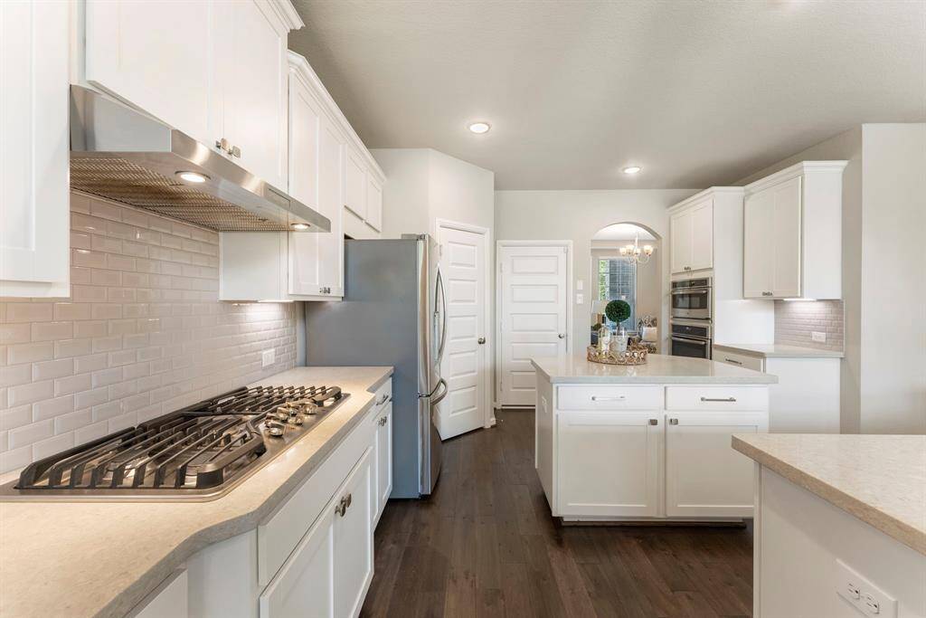 Stainless appliances and plenty of storage available in this beautiful kitchen.  Center island is wrapped in additional cabinets.