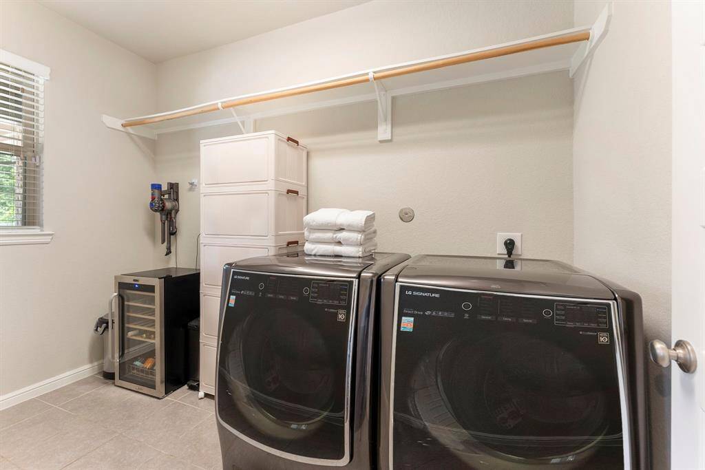 Laundry room sits just behind breakfast room only a few steps away from one of the garage entry doors.