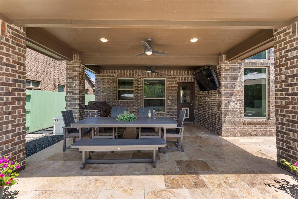 Large covered patio with outdoor kitchen.  Generator sits on this side of house just past the grill.