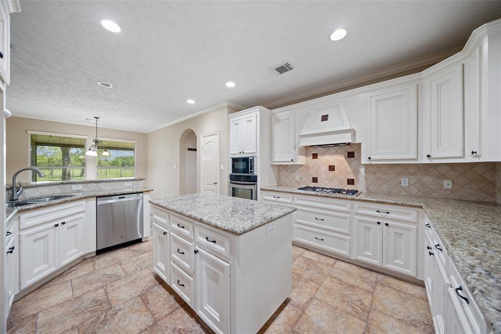 The sink overlooks both the breakfast nook and living area — so even if you're on dish duty, you're still part of the action.