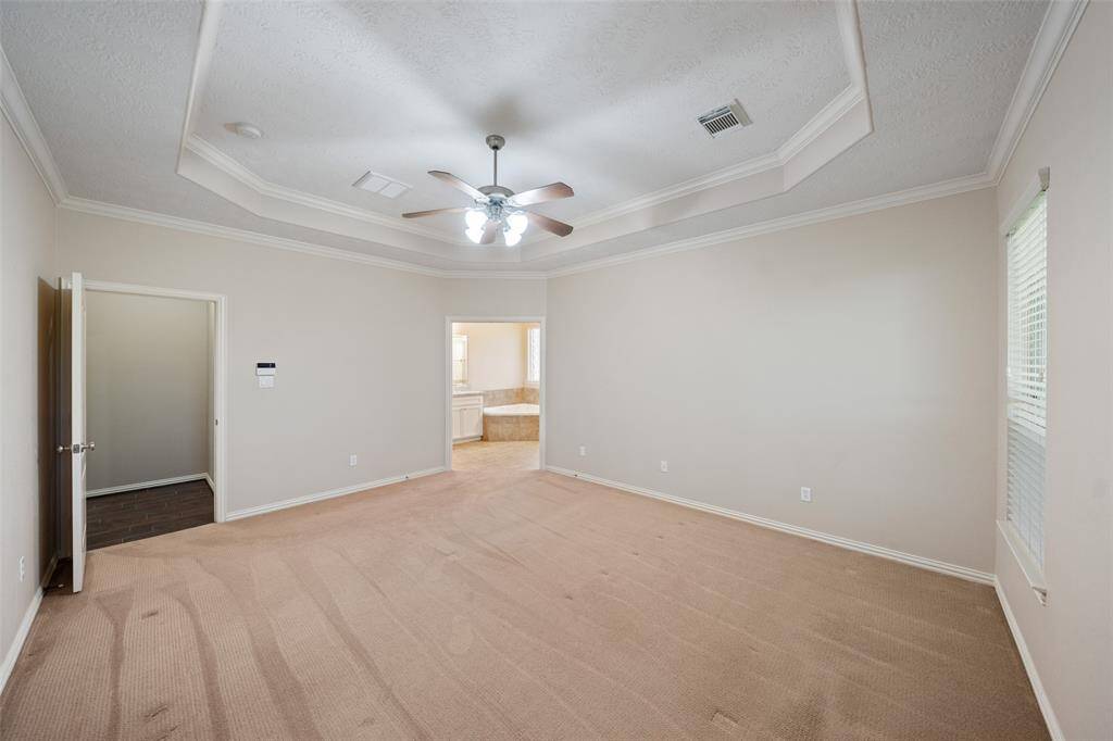 Looking toward the ensuite bath, this room offers a quiet retreat with plenty of wall space for furniture layout options.