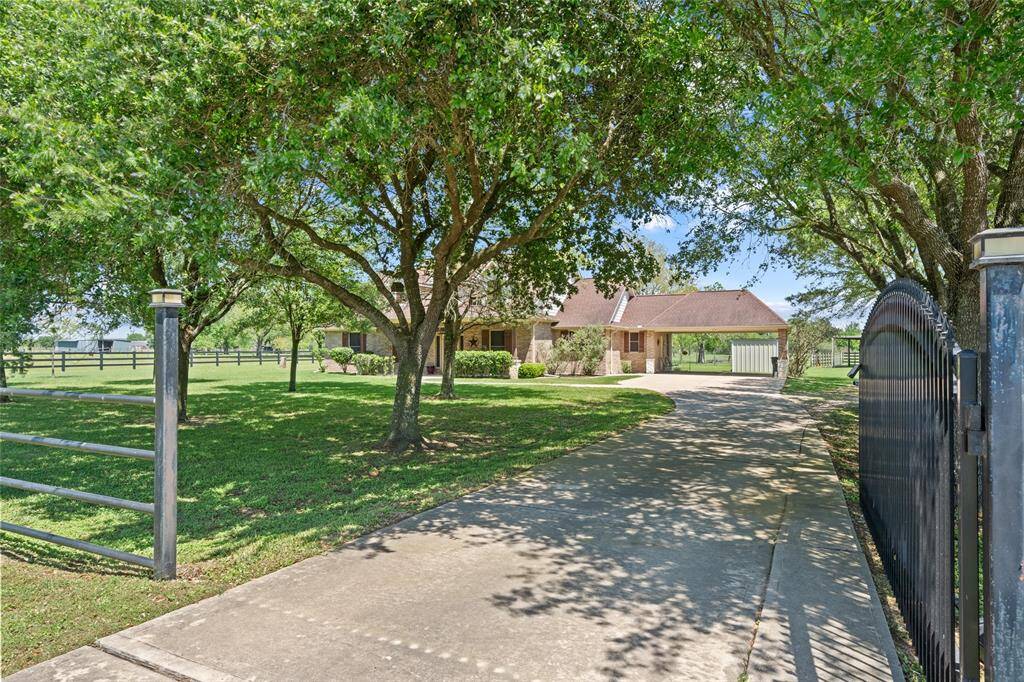 Arrive in style down your private gated drive, shaded by mature trees that welcome you home with peace and privacy.