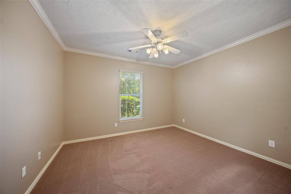 A well-sized bedroom with crown molding and great natural light. Perfect for guests, work-from-home, or playtime.
