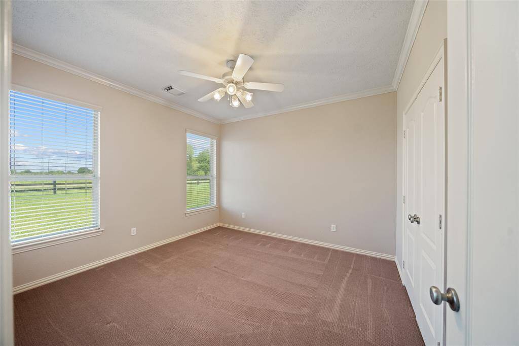 Another generously sized room with peaceful views of the backyard and plenty of closet space.