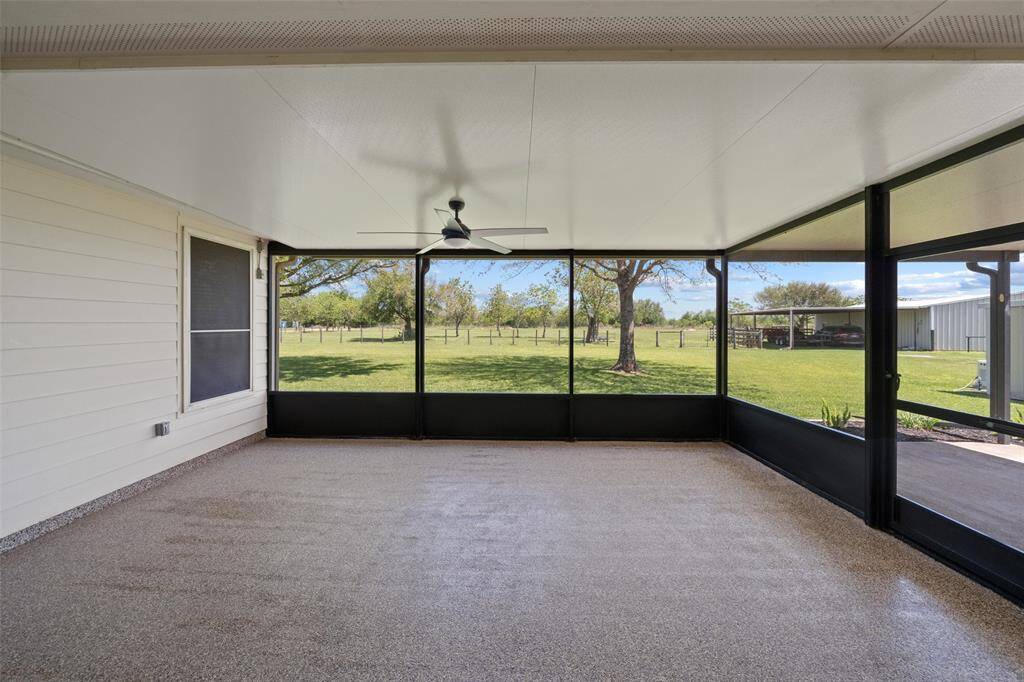 Enjoy the outdoors bug-free on the screened-in porch, complete with ceiling fan and shaded views of the pasture.