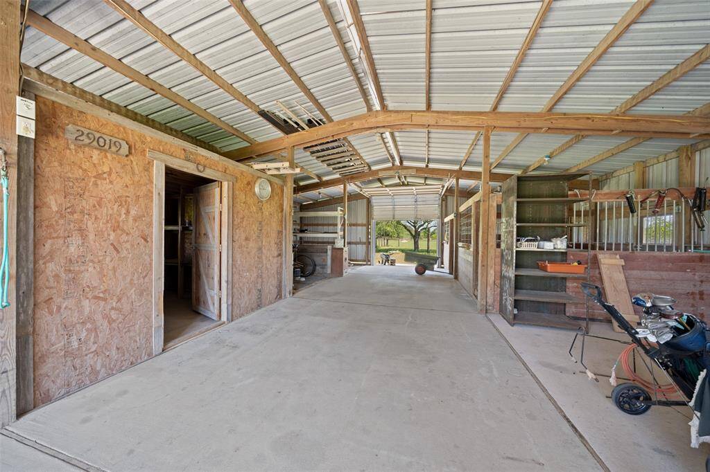Concrete flooring runs the full length of the barn for easy cleaning and year-round use. The structure includes stalls, storage, and a tack/feed room to keep everything organized and dry.