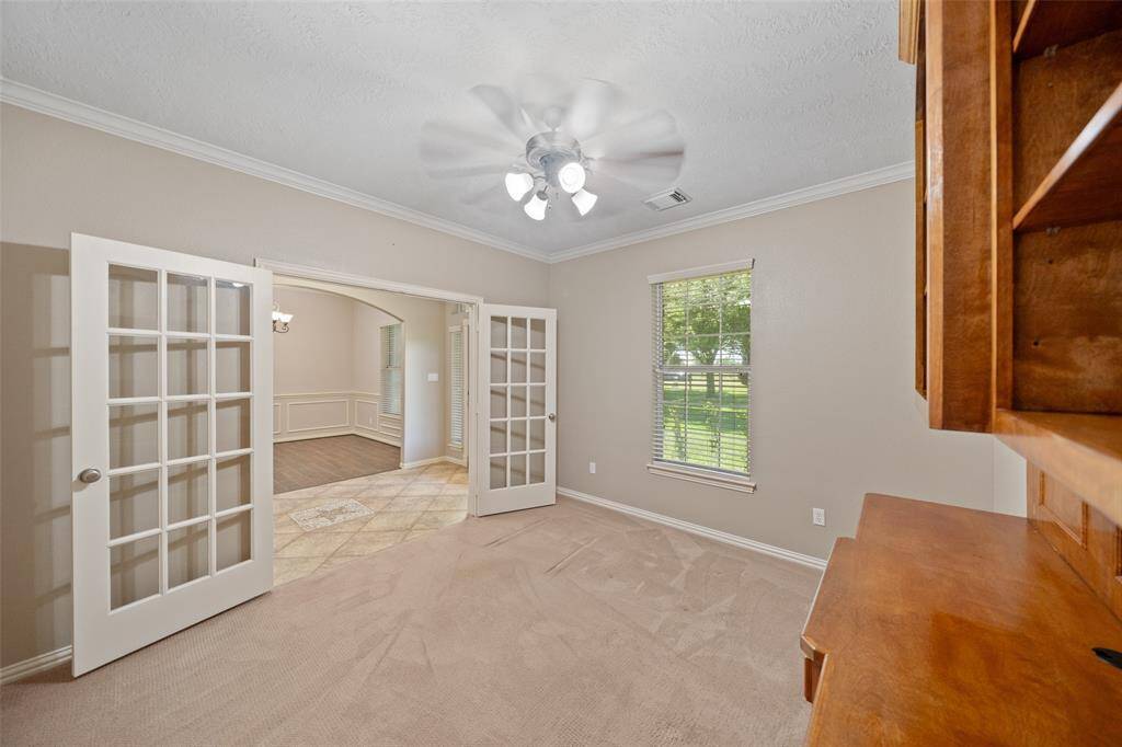 Set just off the entry, this flexible space with French doors and beautiful natural light is perfect for a home office or library.