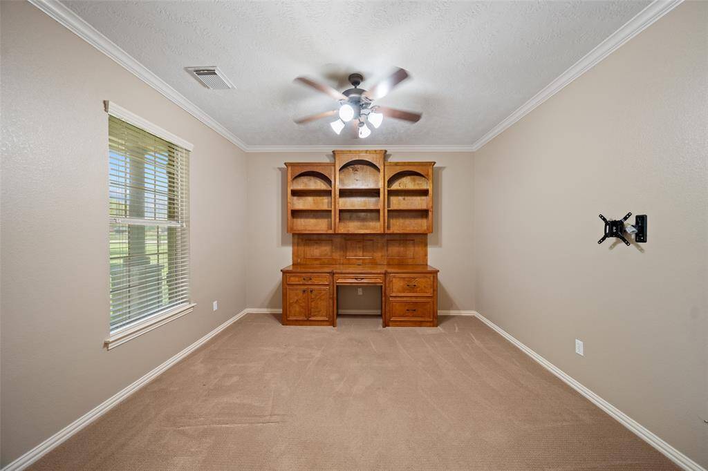 Located just off the entry, this flexible room is perfect for work or relaxation—think home office, reading retreat, or creative corner, all filled with natural light.