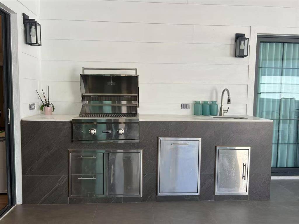 Outdoor kitchen under enclosed patio
