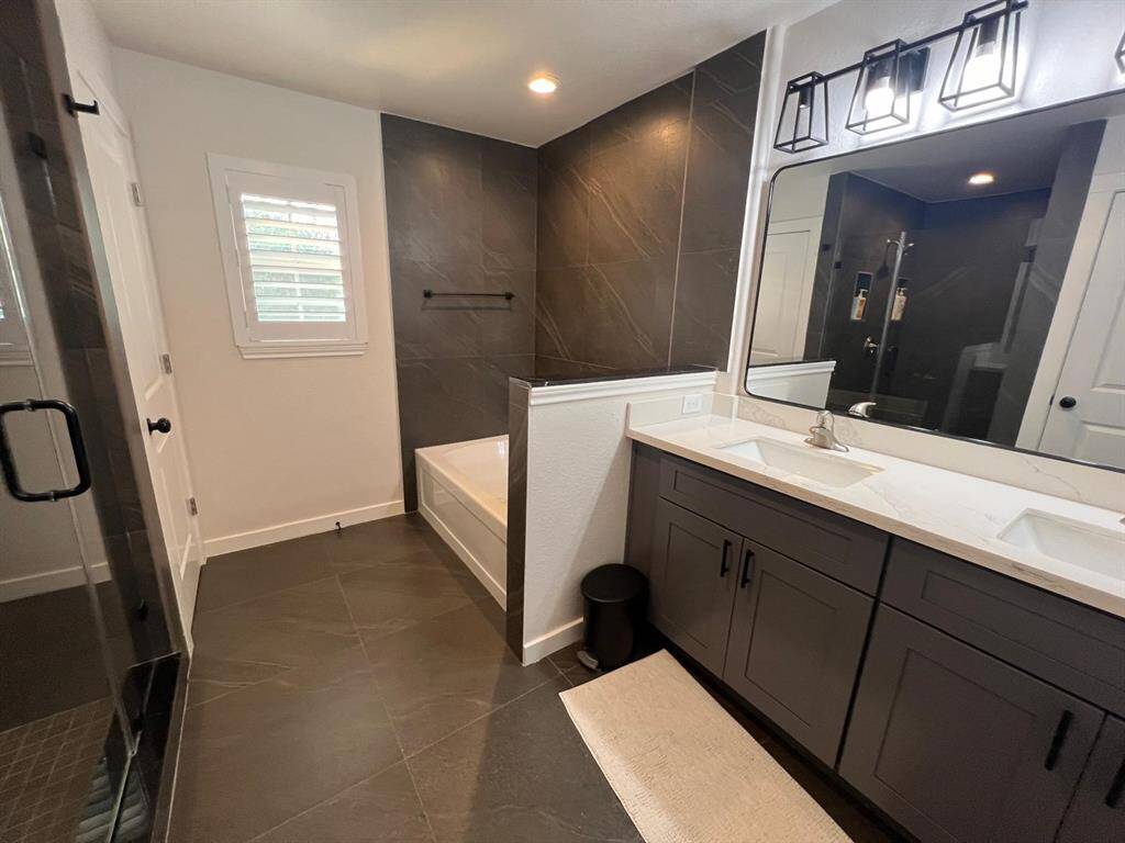 One of Two Full Baths on Second Floor for Guests and Ensuite to One Bedroom.  Soaking Tub, Large Shower, and Private Toilet.
