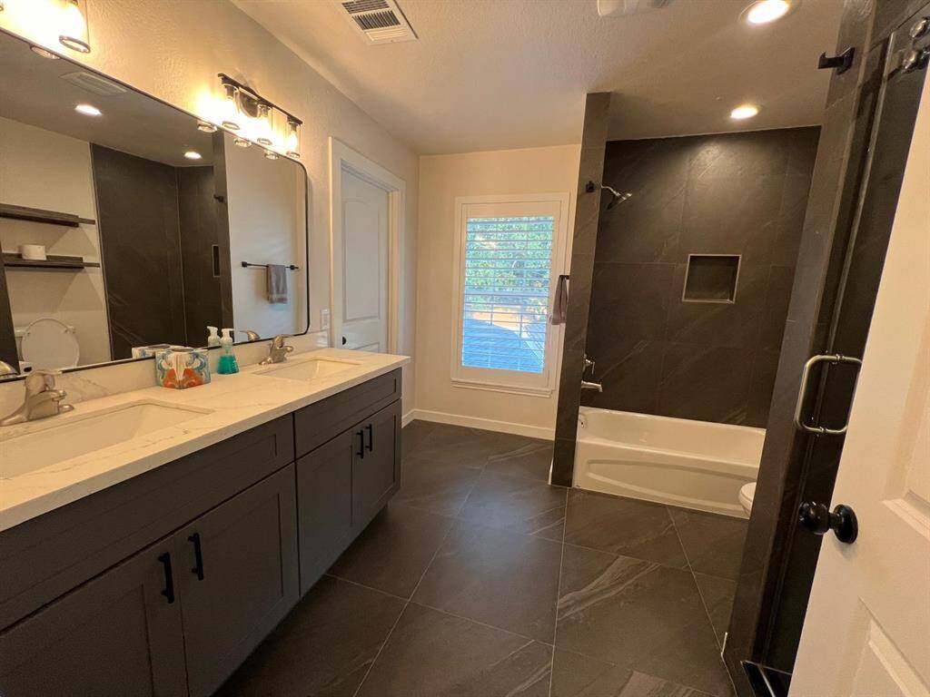 Second of Two Full Baths on Second Floor Shared by 2 Bedrooms.  Tub, Shower, Double Vanity and Toilet.
