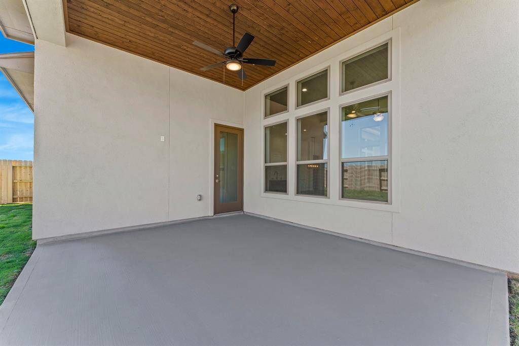 Covered Rear Patio with Fan and Pine Ceiling.