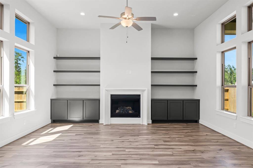 Built-in Storage, Gas Log Fireplace, and Floating Shelving at Family Room.