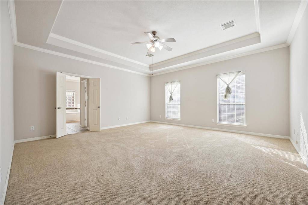 Primary bedroom located directly at the top of the stairs.