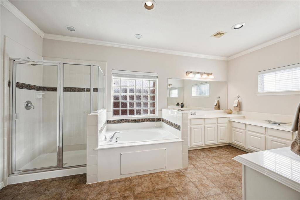 Primary bathroom with separate shower and garden tub.