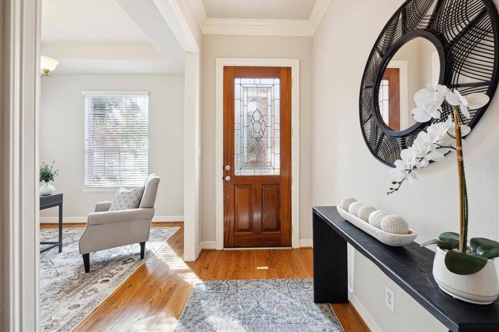 Entry with a view into the formal dining room (staged as an office).