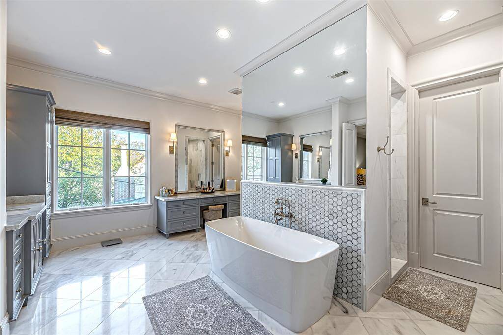 Spa primary bathroom.  Double Vanity, double water closets, make up bar, double shower heads & double primary closets