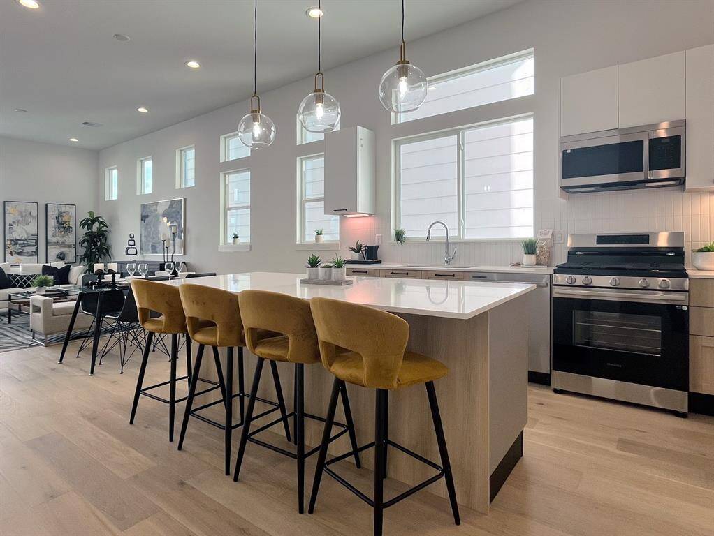 Spacious kitchen island with modern seating, perfect for entertaining and casual dining in a bright, open-concept layout.
