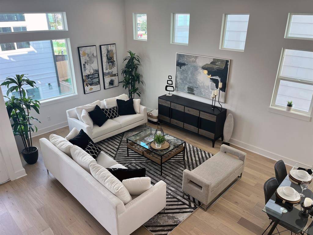 Spacious and inviting living area filled with natural light, featuring modern decor and an open layout perfect for entertaining.