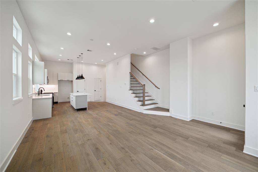 Experience open-concept living with this spacious area combining the living room, dining space, and modern kitchen, perfect for entertaining and everyday comfort.