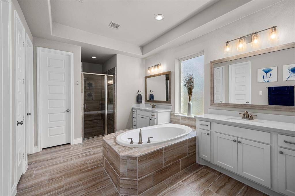 Primary bathroom gives plenty of room, with two separate sinks and two closets