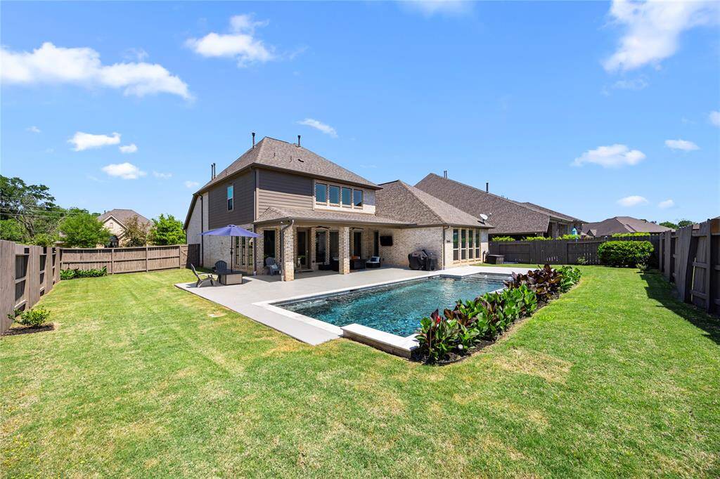 Spacious, manicured yard with stained fence