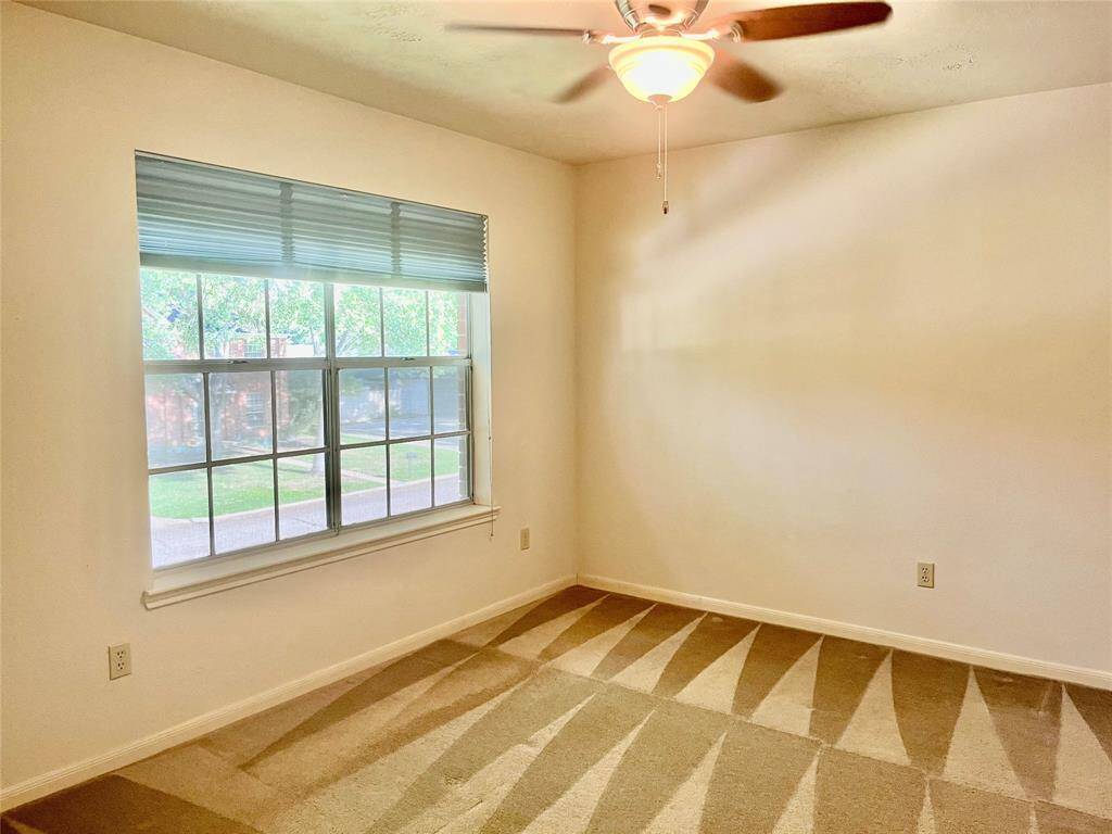 Bedrooms all feature lighted ceiling fans, large windows, and neutral-toned carpet and paint.