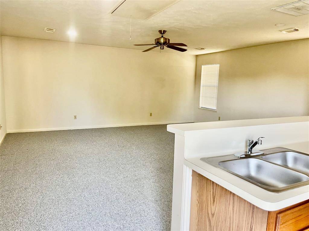 The second-floor garage apartment features a wet bar that could easily be converted into a kitchenette, along with a full bathroom—ideal for guests, in-laws, or rental income.
