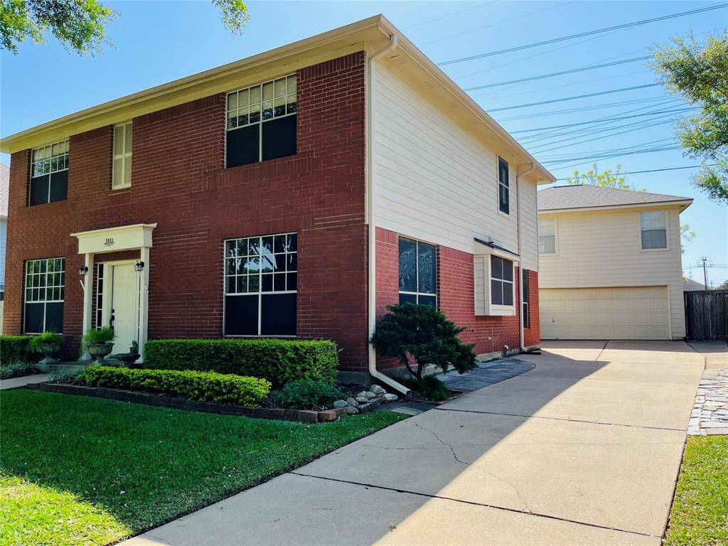 Additional highlights include an oversized garage with a workshop area, and a long driveway offering ample off-street parking for family and guests.