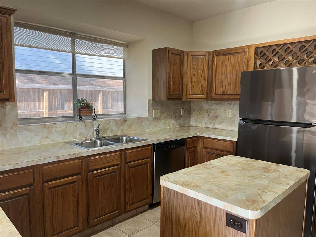 Solid wood kitchen cabinets include a built-in wine rack.