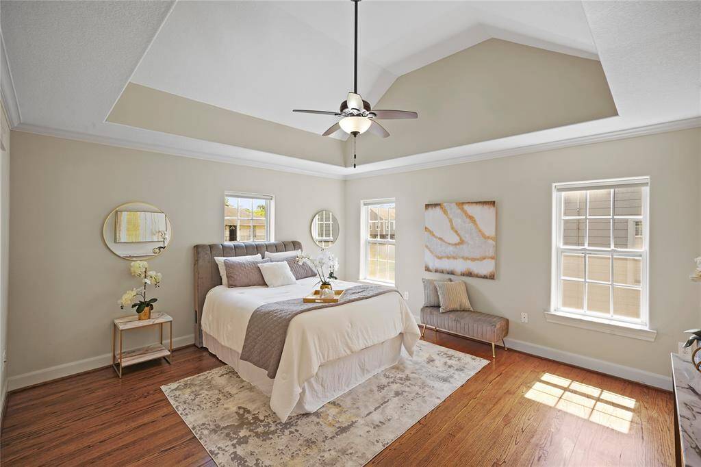 This bright and airy primary bedroom is flooded with natural light, featuring a private ensuite for added convenience.