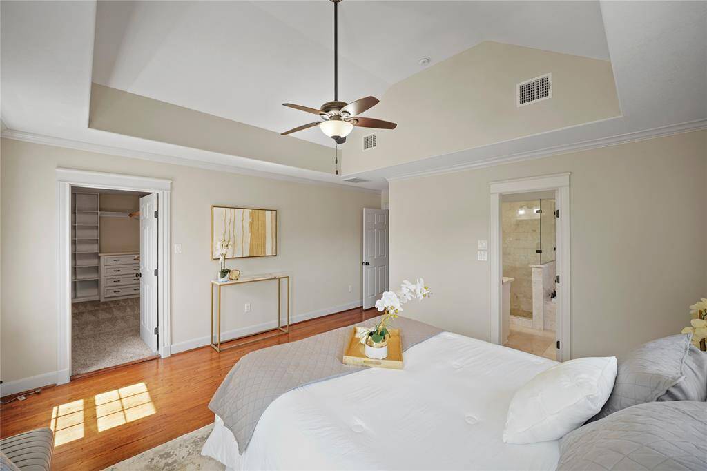 This view highlights the spacious entry into the expansive custom closet, designed with ample storage and elegant organization for a luxurious, functional experience.