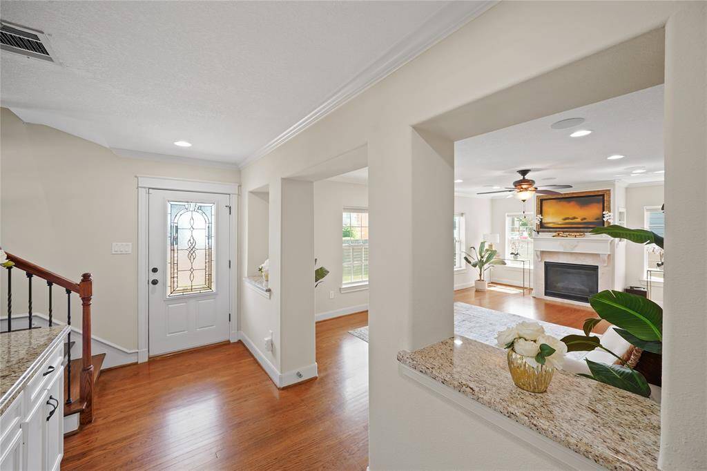 Step into the formal entryway, offering a graceful view of the stylish living room.