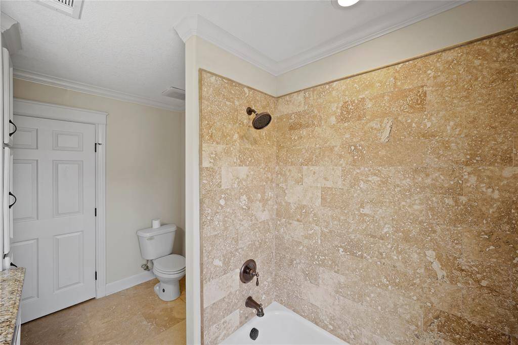 The upstairs bathroom offers ample space, abundant storage, and plenty of natural lighting.