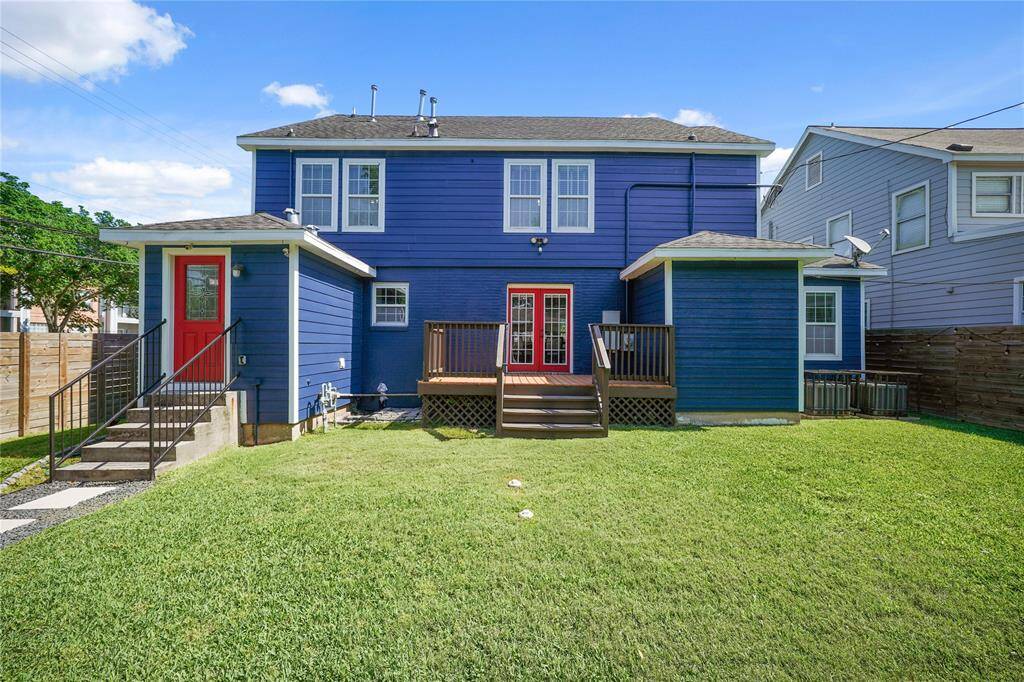 The exterior backside of the house showcases the convenient laundry room entry and access to the porch.
