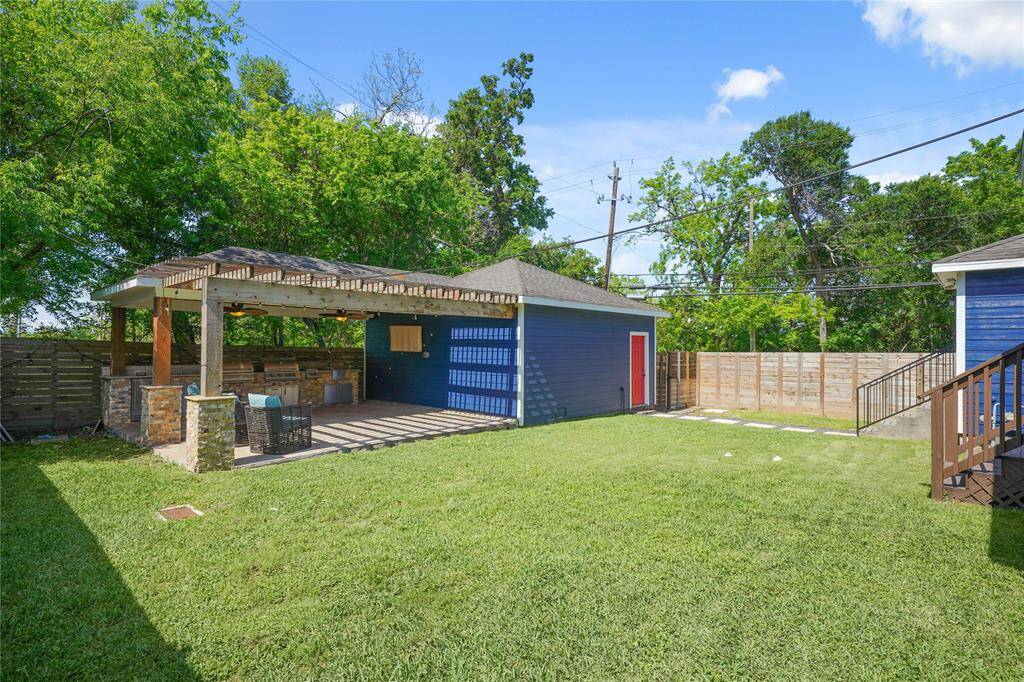 Notice the privacy fencing surrounding the backyard, offering both security and a sense of seclusion for a peaceful outdoor experience.