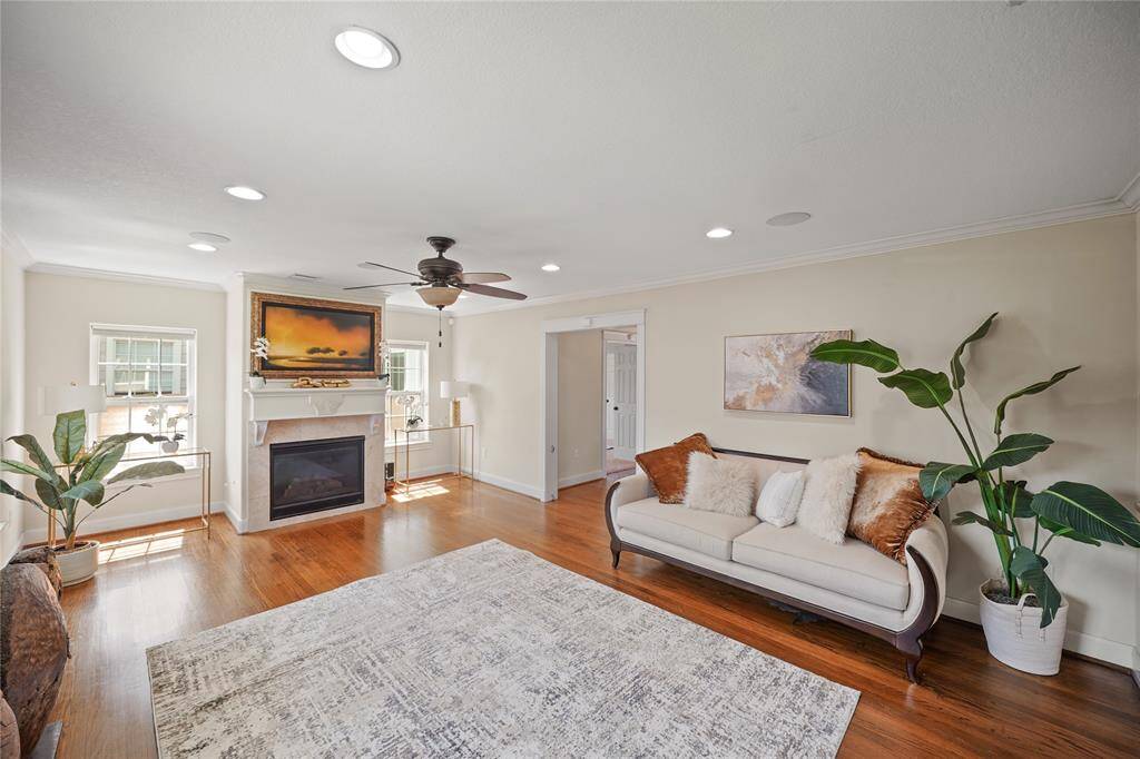 Enjoy your very own cozy fireplace featuring a flatscreen television mounted above the retractable art print screen, all seamlessly integrated with an in-ceiling theater speaker system.
