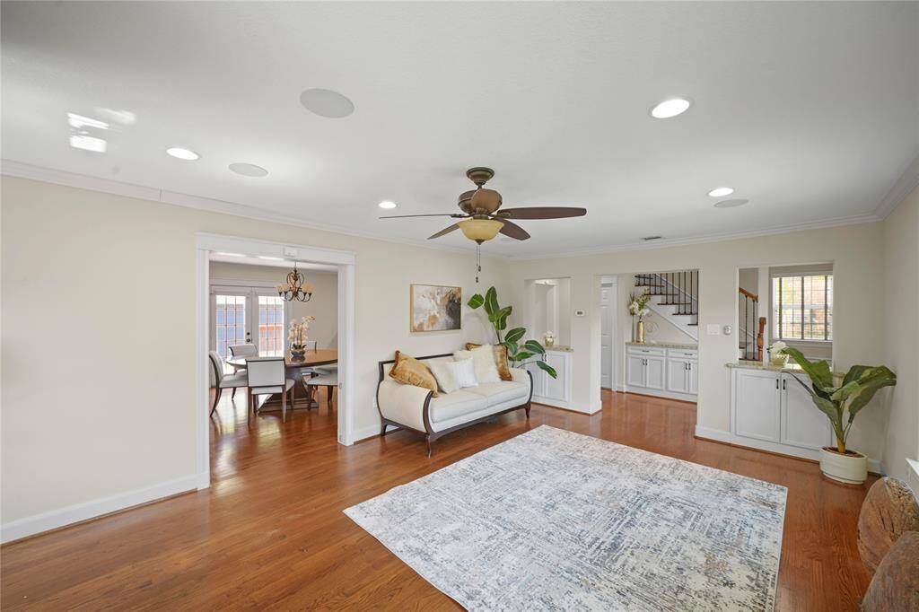 The living room flows effortlessly into the dining space, distinct yet connected—offering a sense of openness while maintaining defined areas for entertaining and everyday living.
