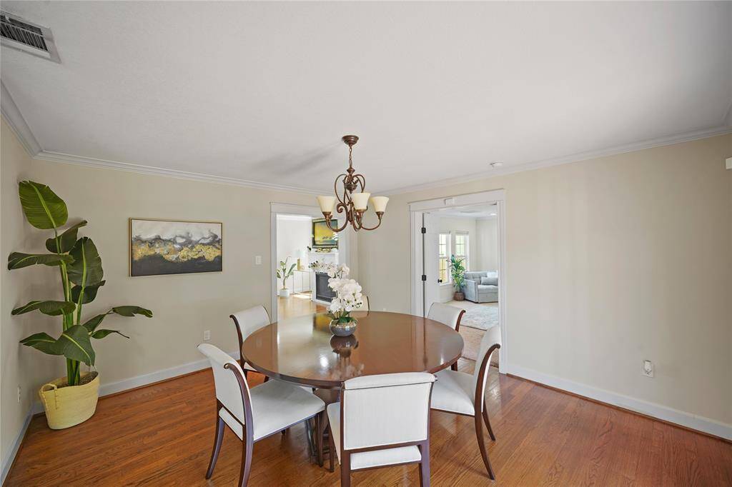 Bask in the abundance of natural light that flows into this open dining area, seamlessly connecting the kitchen and living spaces and creating an inviting setting for intimate meals and lively gatherings.