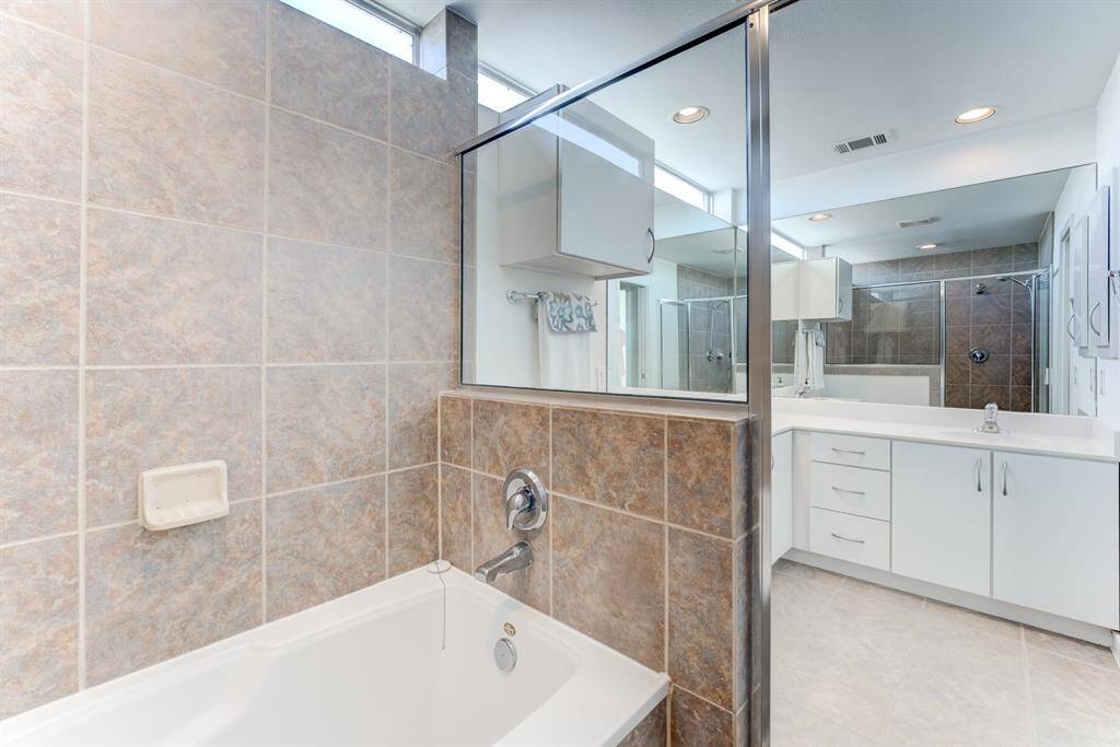 Primary bathroom boasts his and her sink, with garden tub and separate walk-in shower!